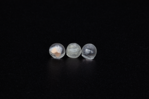 TX-1, three resin spheres with embedded materials, each approximately 4-5mm in diameter; pre-launch photo; credit, Adriana Knouf